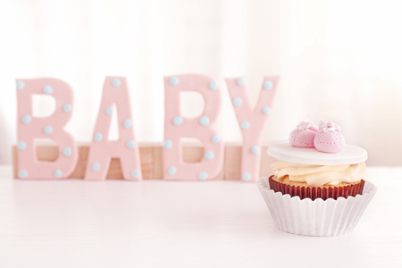 Word "Baby" with cupcake on light backgroundの写真素材