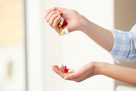 Woman taking vitamins, closeupの写真素材