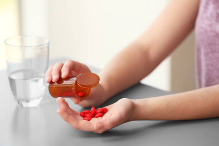 Woman taking vitamins, closeupの写真素材
