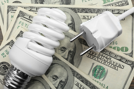 Electric bulb on dollars background