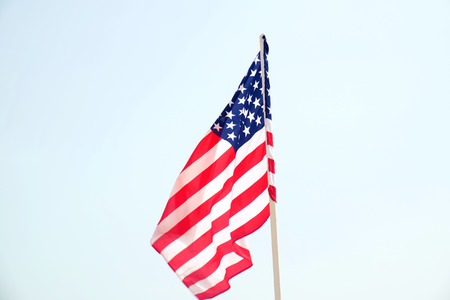 American flag on blue sky background