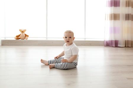 Baby boy sitting in the room