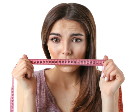 Woman with locked mouth for diet isolated on whiteの写真素材
