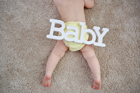 Baby and decorative word on the floorの写真素材