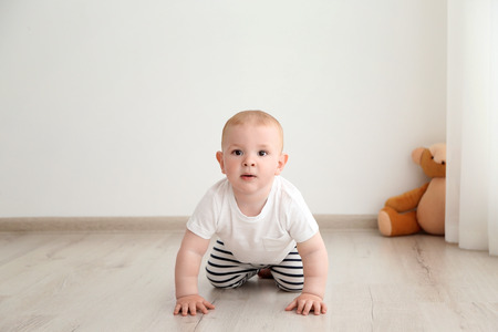 Baby boy crawling in the room