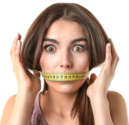 Woman with locked mouth for diet isolated on whiteの写真素材
