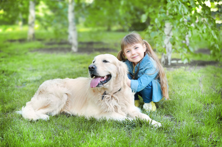 Little girl and big kind dog in the parkの写真素材