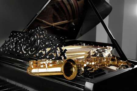 Saxophone lying on the piano, close upの写真素材