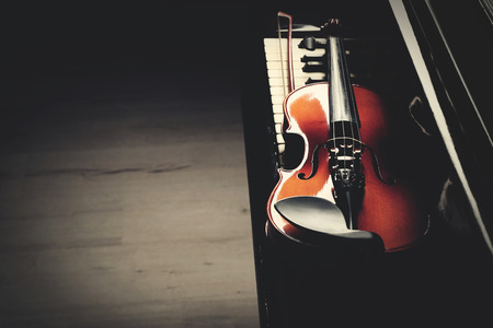 Violin lying on piano keys, close upの写真素材