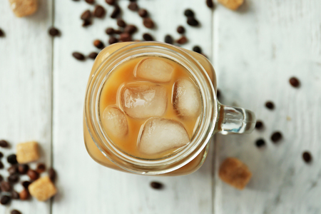 Iced coffee with milk on wooden backgroundの写真素材