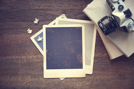 Vintage photos with camera on wooden backgroundの写真素材