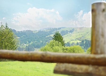 Wooden fence on green hillの写真素材