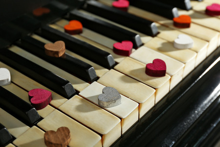 Colourful hearts on piano keys, close upの写真素材