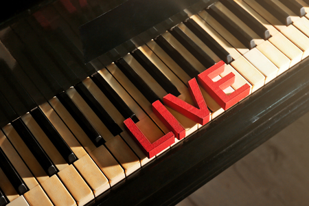 Word LIVE on piano keys, close upの写真素材