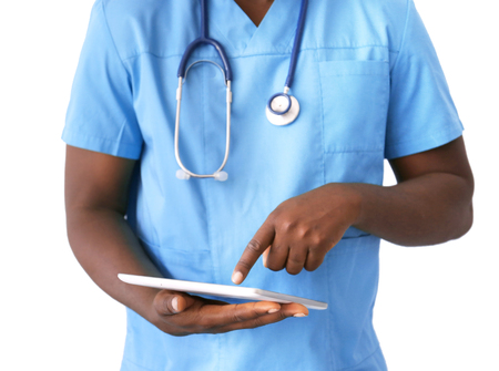 Professional African doctor with tablet on light backgroundの写真素材
