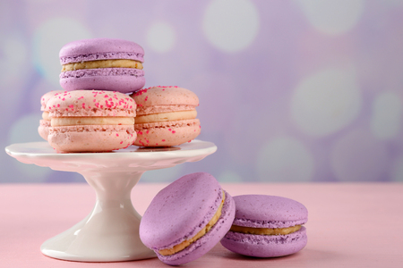 Tasty macaroons on stand on tableの写真素材