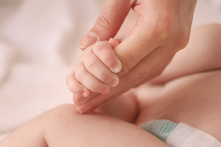 Child hand holding parent hand, closeupの写真素材