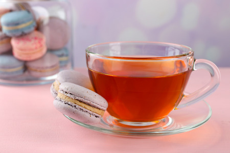 Tasty macaroons with tea on tableの写真素材
