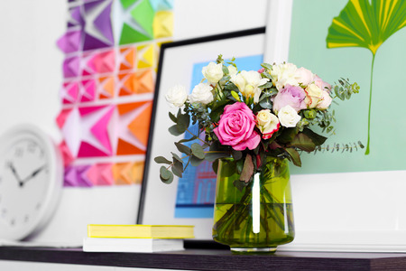 Beautiful bouquet of colourful roses in glass vaseの写真素材