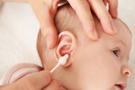Cleaning small baby earsの写真素材