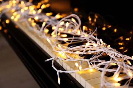 Christmas lights on piano keys, closeupの写真素材