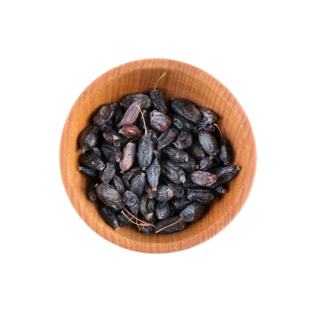 Dried barberry in small wooden bowl isolated on whiteの写真素材