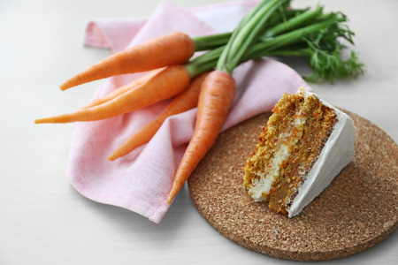 Tasty slice of carrot cake on cork plateの写真素材
