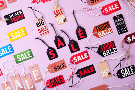 Samples of paper tags with strings and word sale on pink backgroundの写真素材