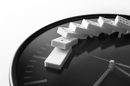 Dominoes and clock on light backgroundの写真素材