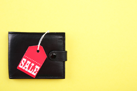 Wallet with sale tag on yellow backgroundの写真素材