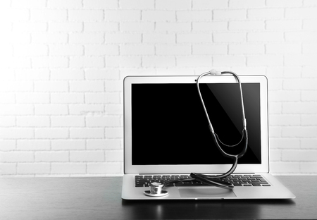 Laptop with stethoscope, isolated on whiteの写真素材