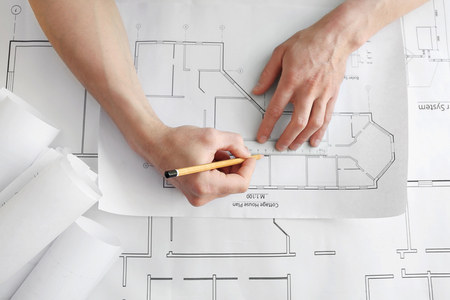 Man working with engineer blueprints