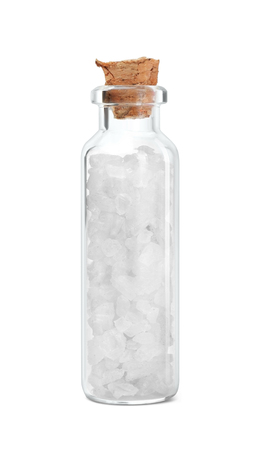 Rough salt in glass bottle on white backgroundの写真素材