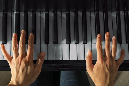 Female hands playing pianoの写真素材