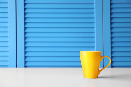 Cup on blue folding screen backgroundの写真素材