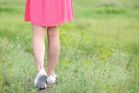 Woman legs on green grassの写真素材