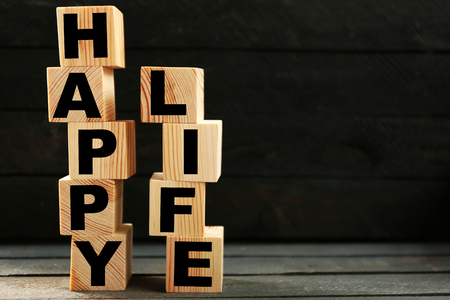 Words HAPPY LIFE on dark backgroundの写真素材