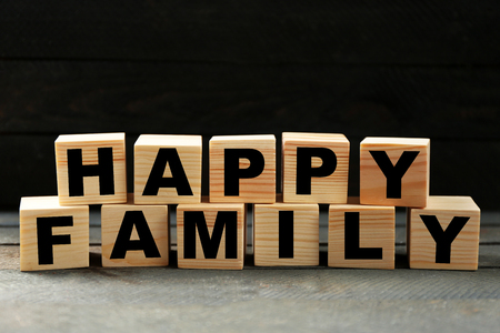 Words HAPPY FAMILY on dark backgroundの写真素材