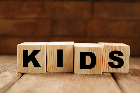 Word KIDS on wooden backgroundの写真素材