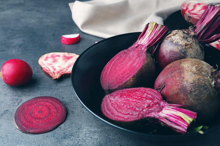 Beet slices with radishes on grey tableの写真素材