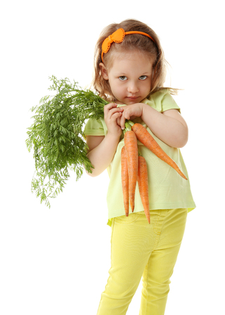 Beautiful girl with carrots, isolated on whiteの写真素材