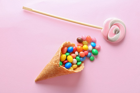 Dessert in ice cream cone on pink backgroundの写真素材