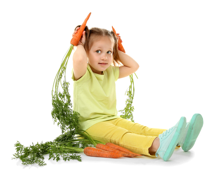 Beautiful girl with carrots, isolated on whiteの写真素材