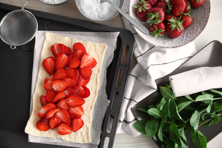 Strawberry dessert on oven tray in kitchenの写真素材