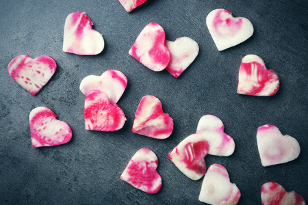 Heart shape beet slices on grey tableの写真素材