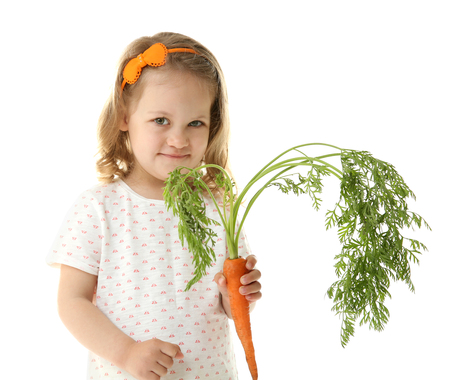 Beautiful girl with carrot, isolated on whiteの写真素材