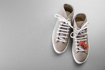 Grey shoes on grey background. Sale conceptの写真素材