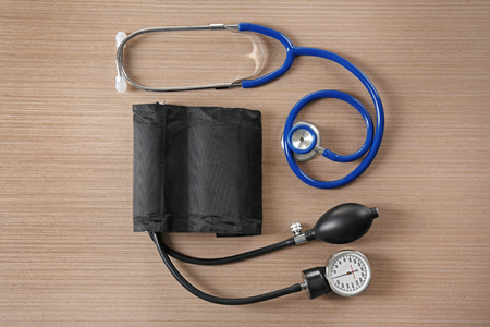 Stethoscope and tonometer on wooden tableの写真素材