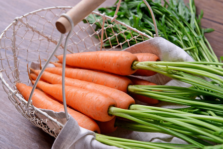 Fresh carrots in wicker basket, closeupの写真素材