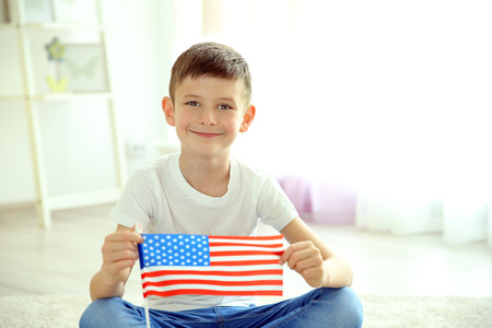 Boy and American flag in roomの写真素材